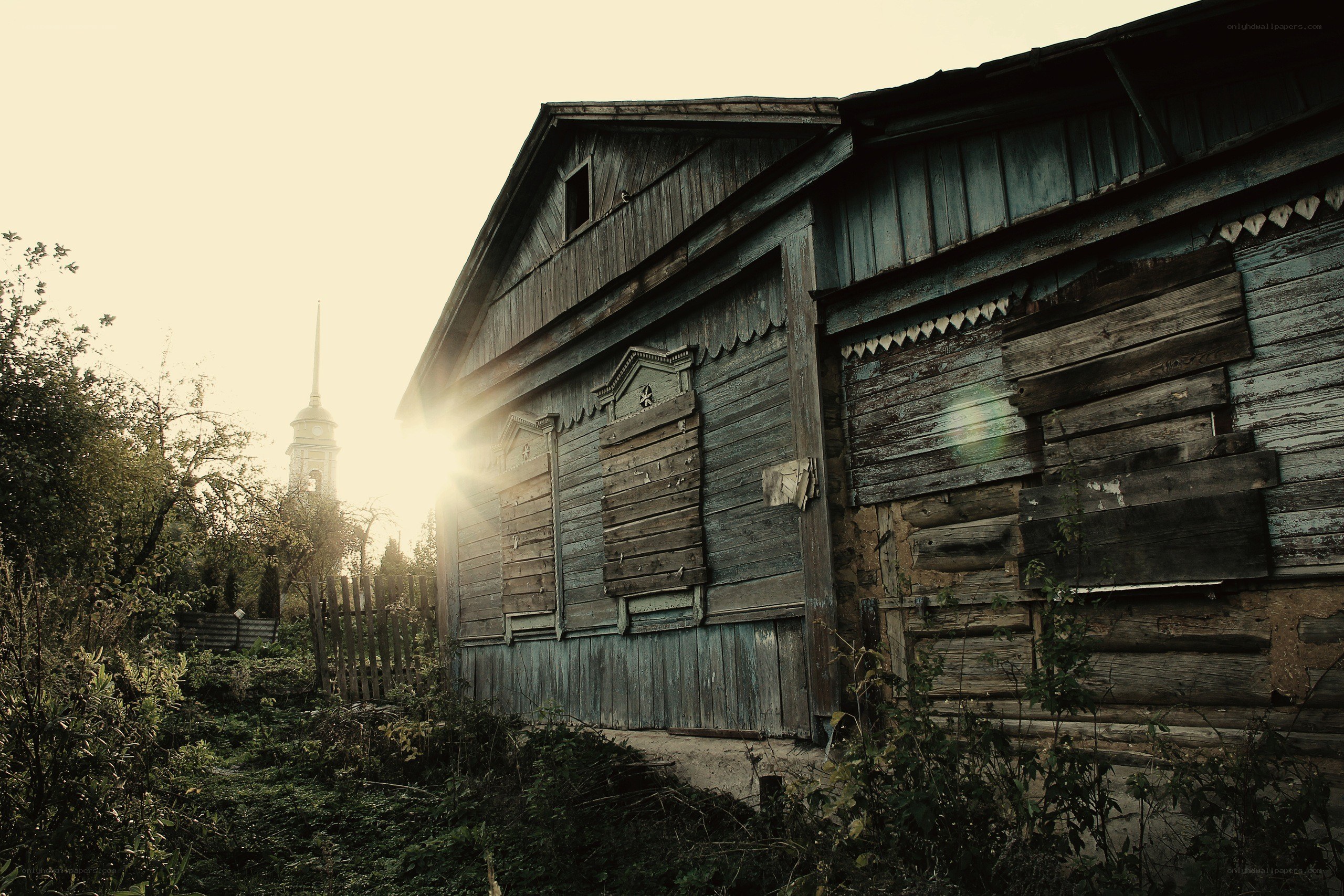 abandoned wooden house at sunset