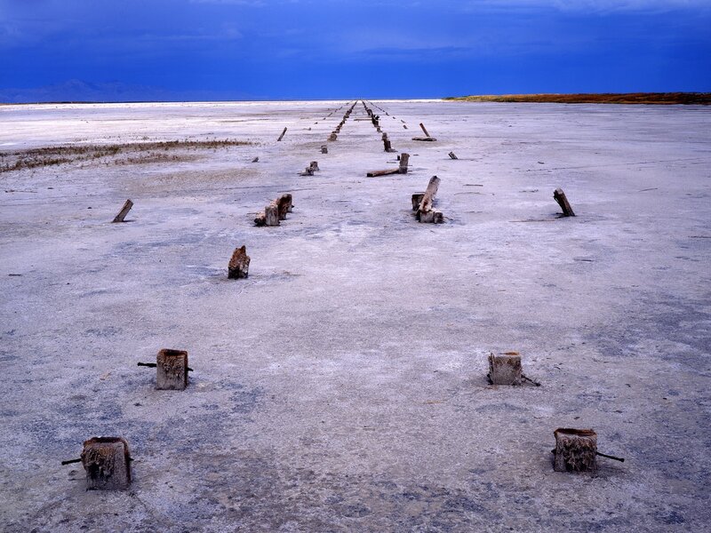 abandoned wooden posts on salt flat