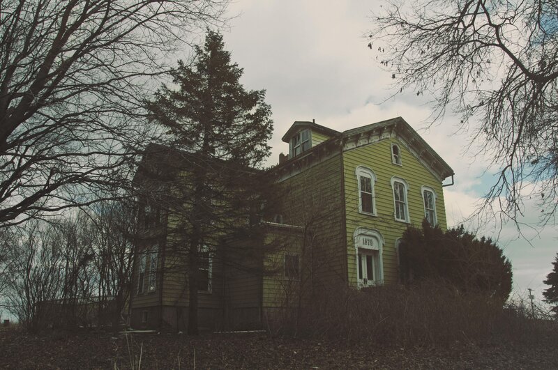 Abandoned yellow house in winter