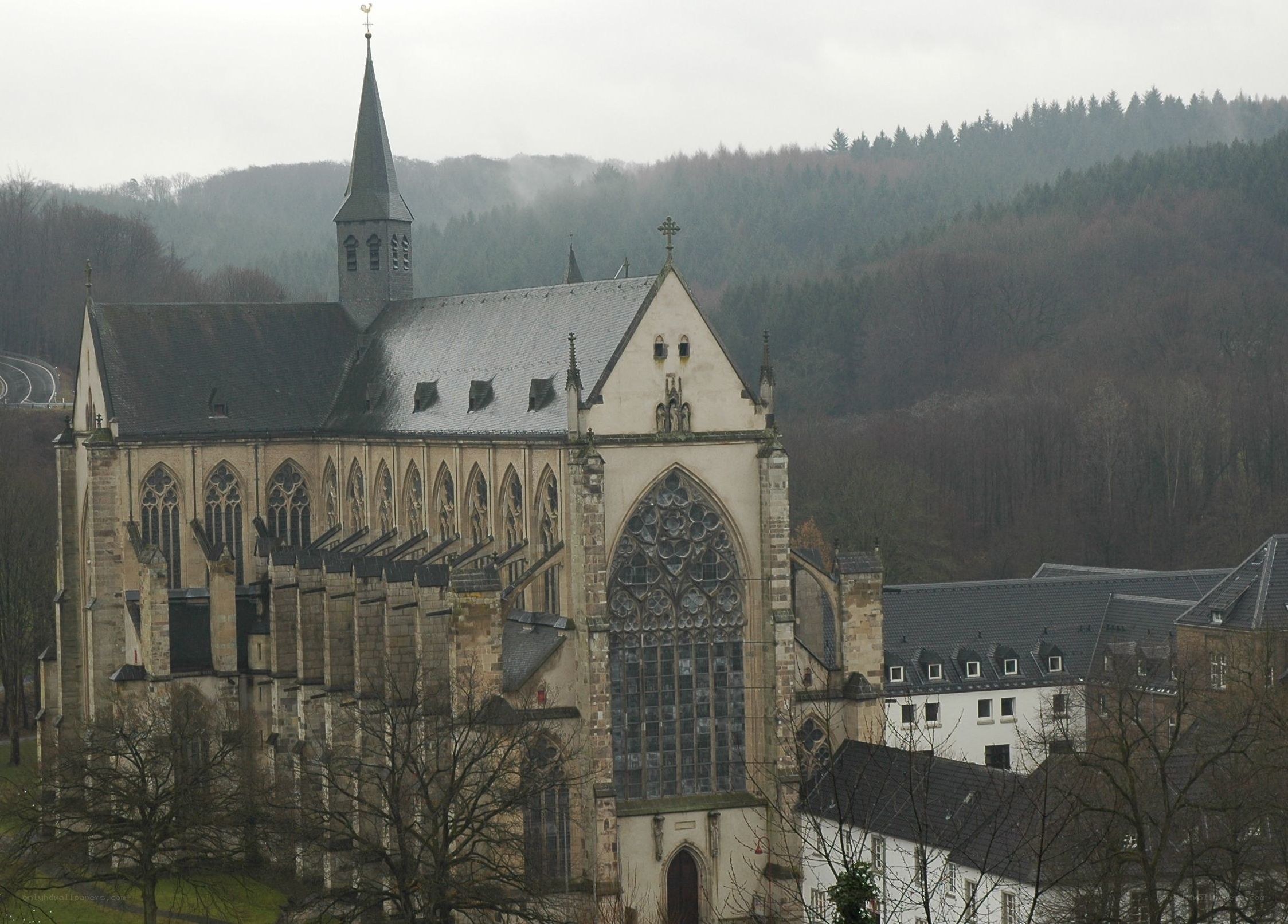 abbey in a forested valley