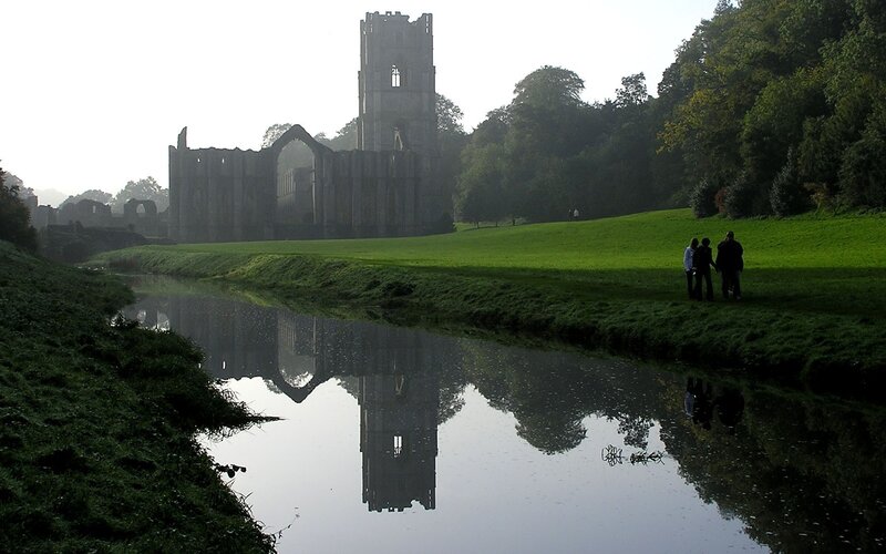 abbey ruins reflected in river