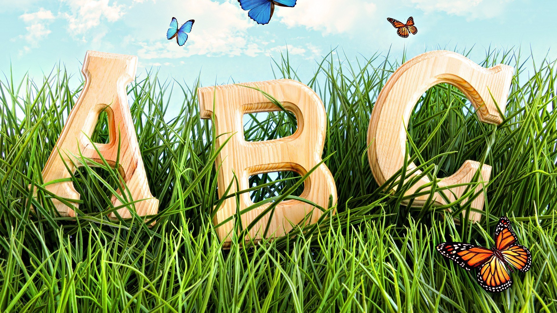 ABC letters in grass with butterflies