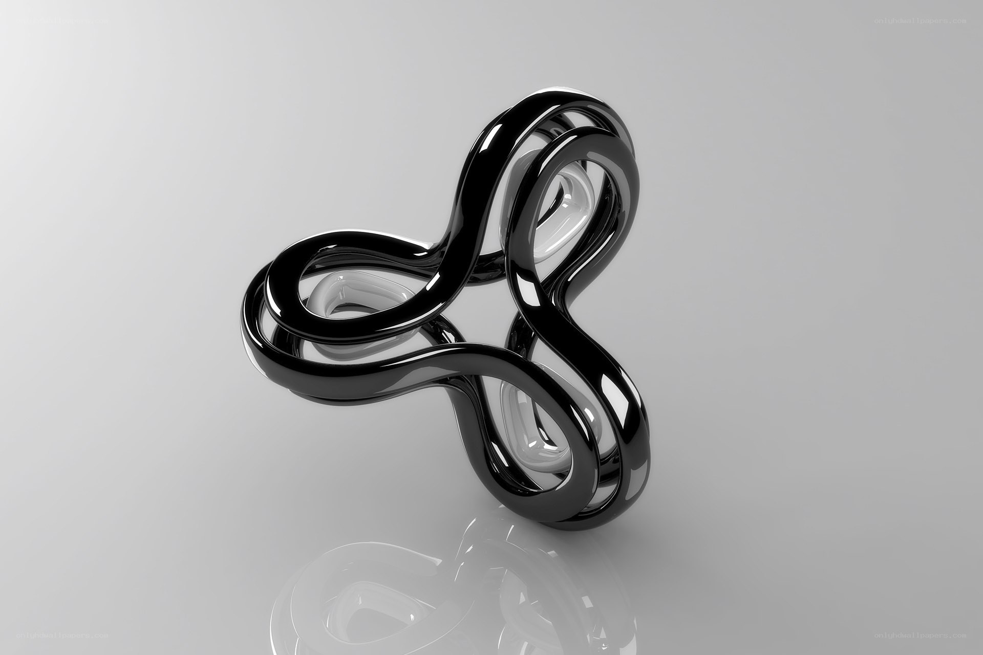 Abstract black sculpture on reflective surface