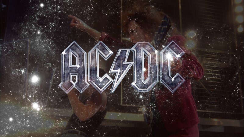 AC/DC band logo with concert scene