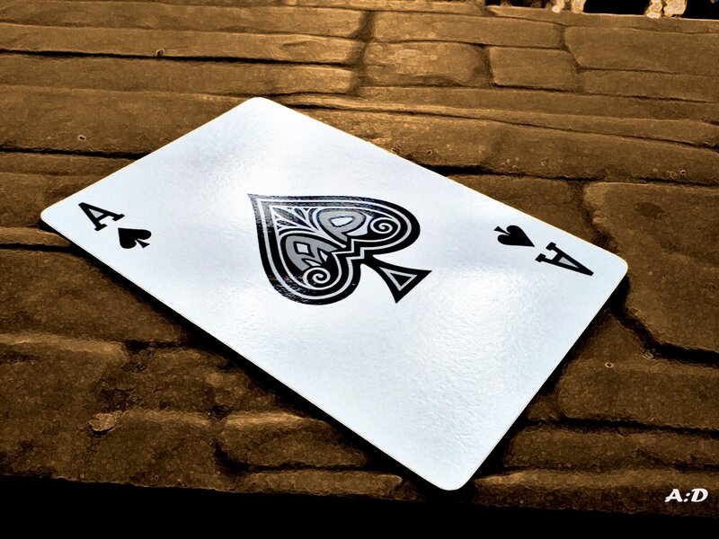 Ace of Spades on wooden surface