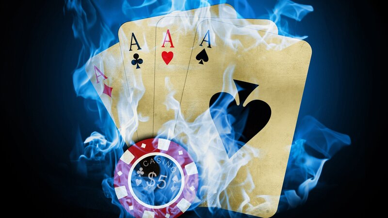 aces and poker chip in flames