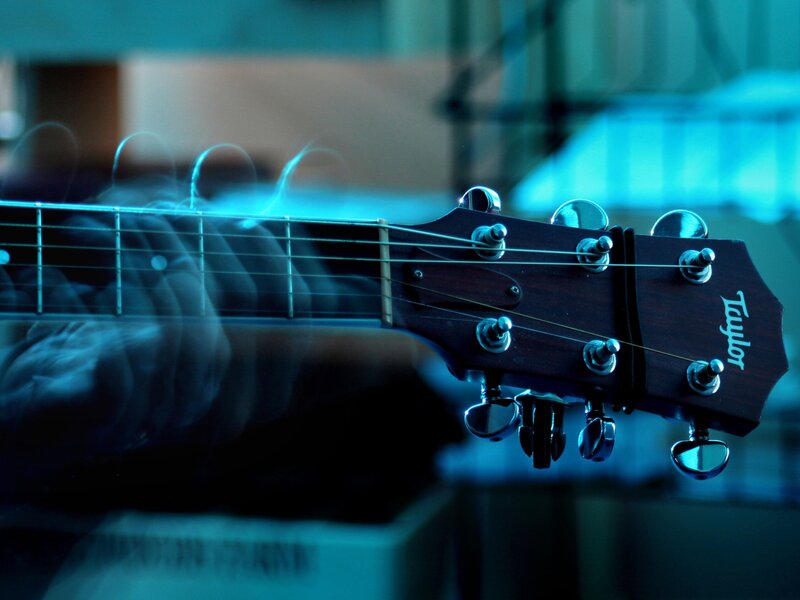 Acoustic guitar headstock in blue light