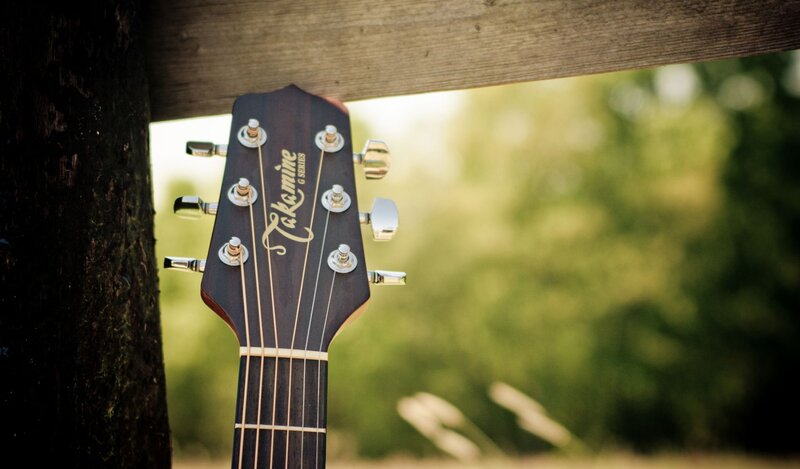Acoustic guitar headstock outdoors