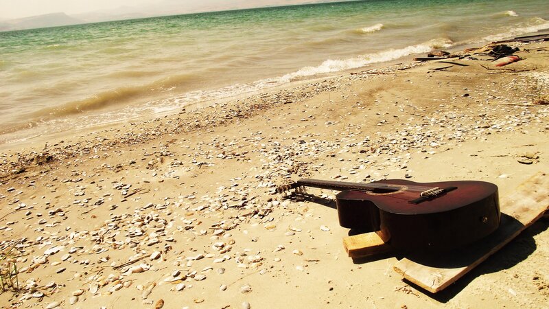 Acoustic Guitar on Beach — Brown
