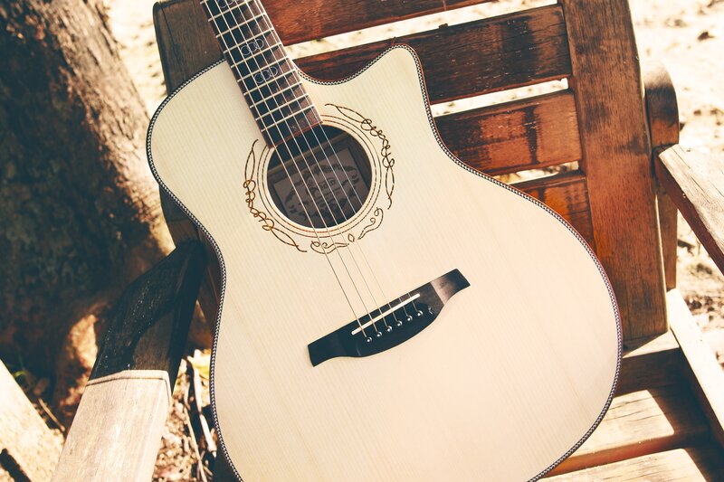 Acoustic Guitar on Bench — Beige