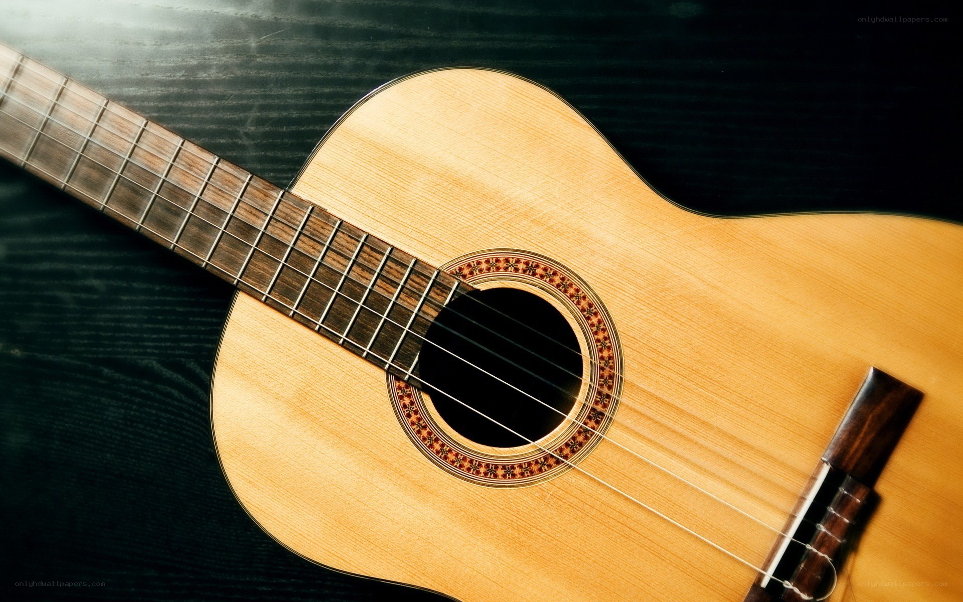 acoustic guitar on dark surface