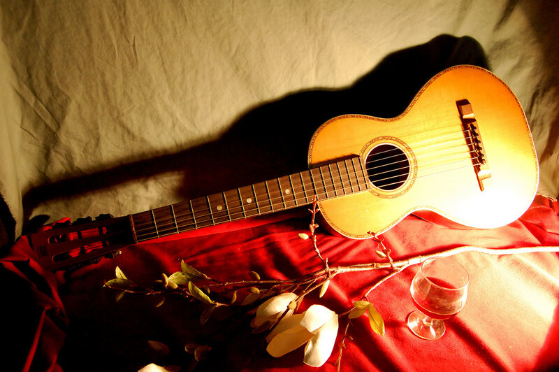 Acoustic Guitar on Red Cloth