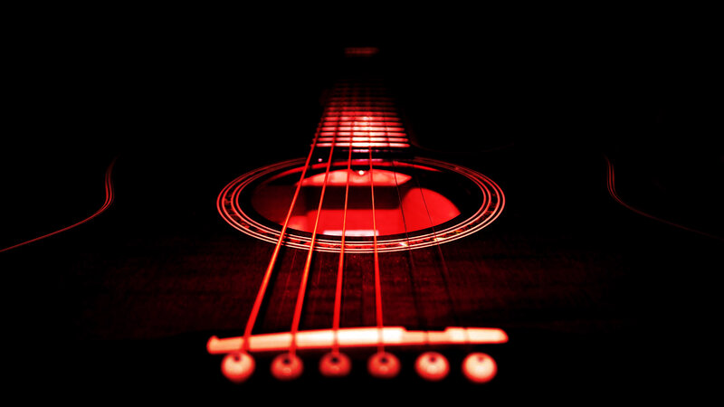 Acoustic guitar with red lighting