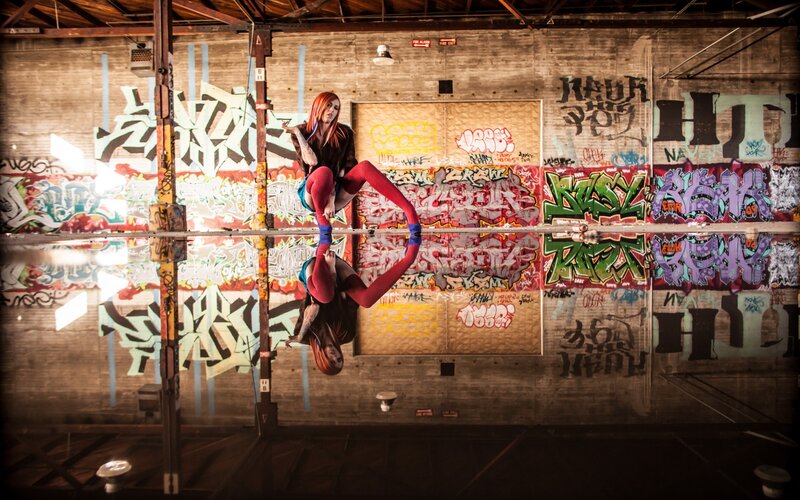 Acrobat on graffiti wall
