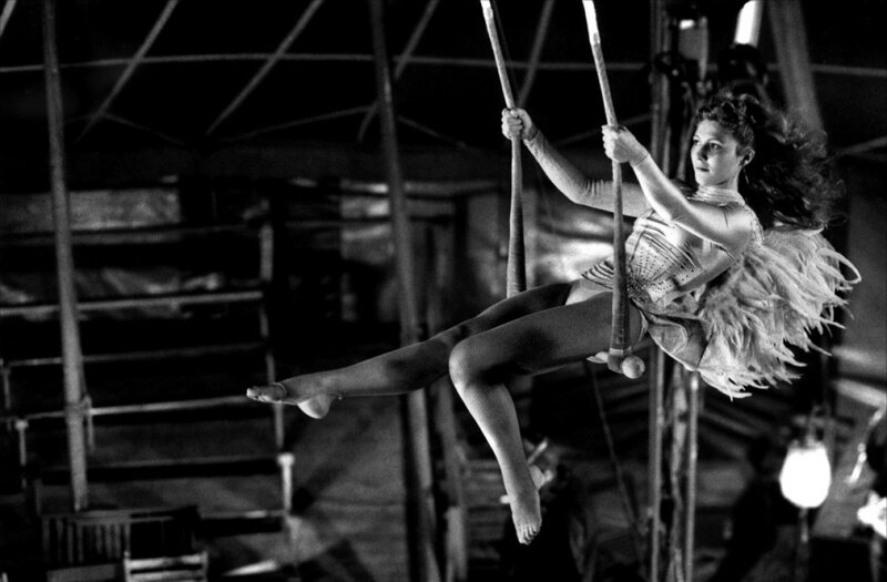 Acrobat on trapeze in circus
