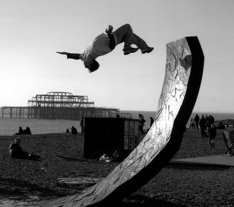Acrobat performing flip on beach