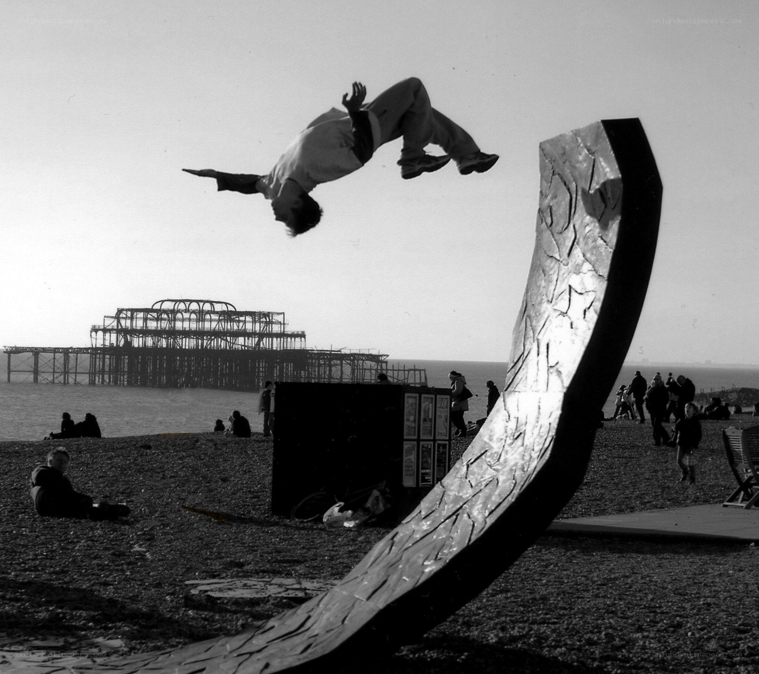 Acrobat performing flip on beach