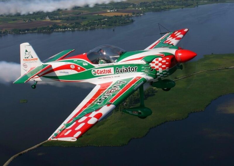 Acrobatic airplane over a lake