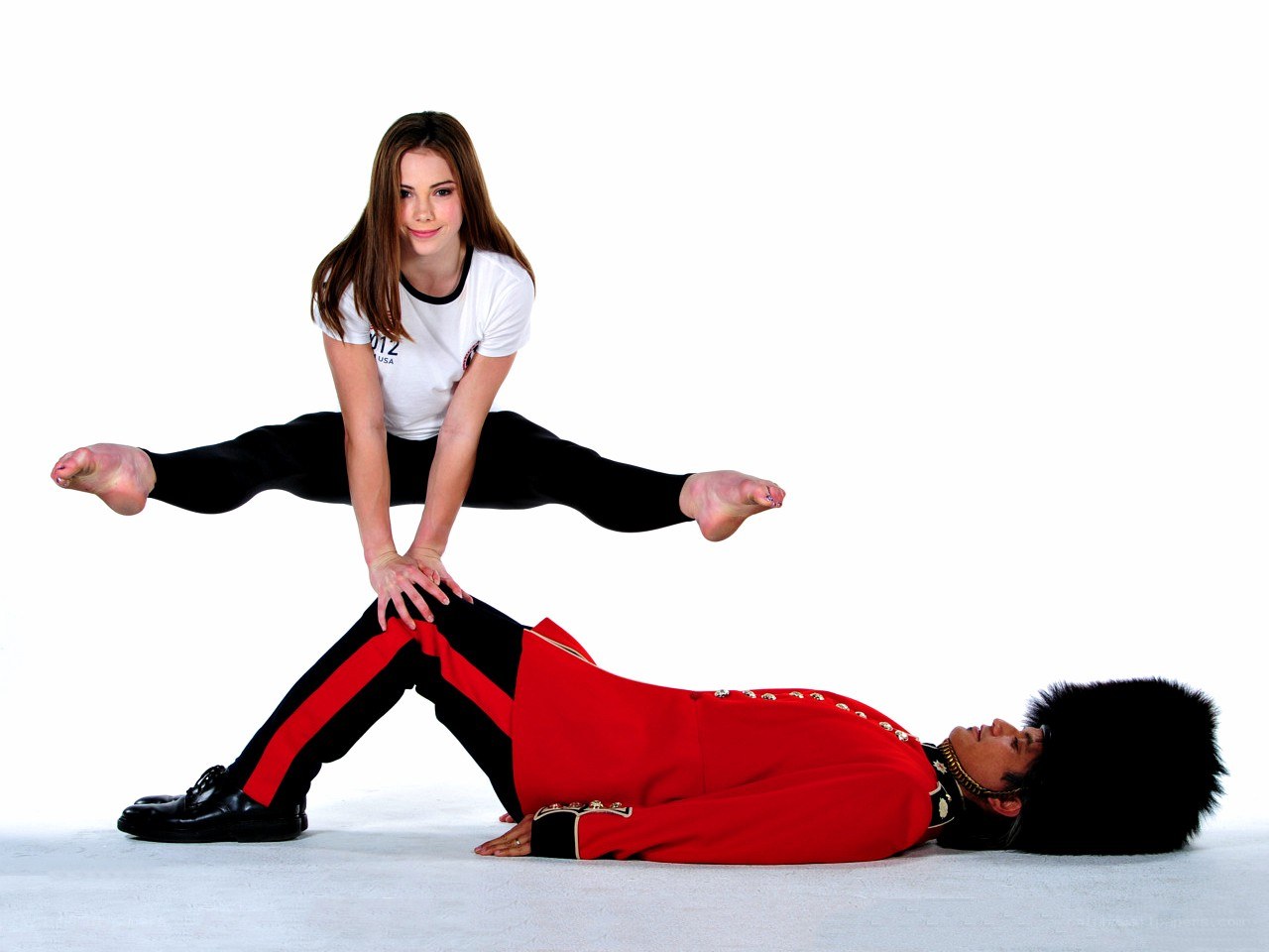 Acrobatic dance duo in red uniform