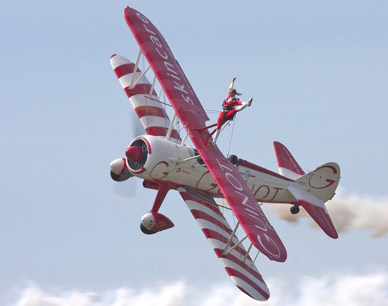 Acrobatic pilot in red biplane