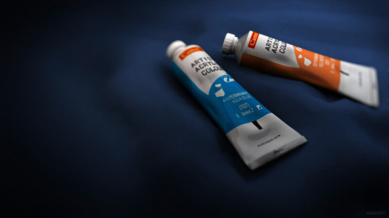 Acrylic paint tubes on blue fabric