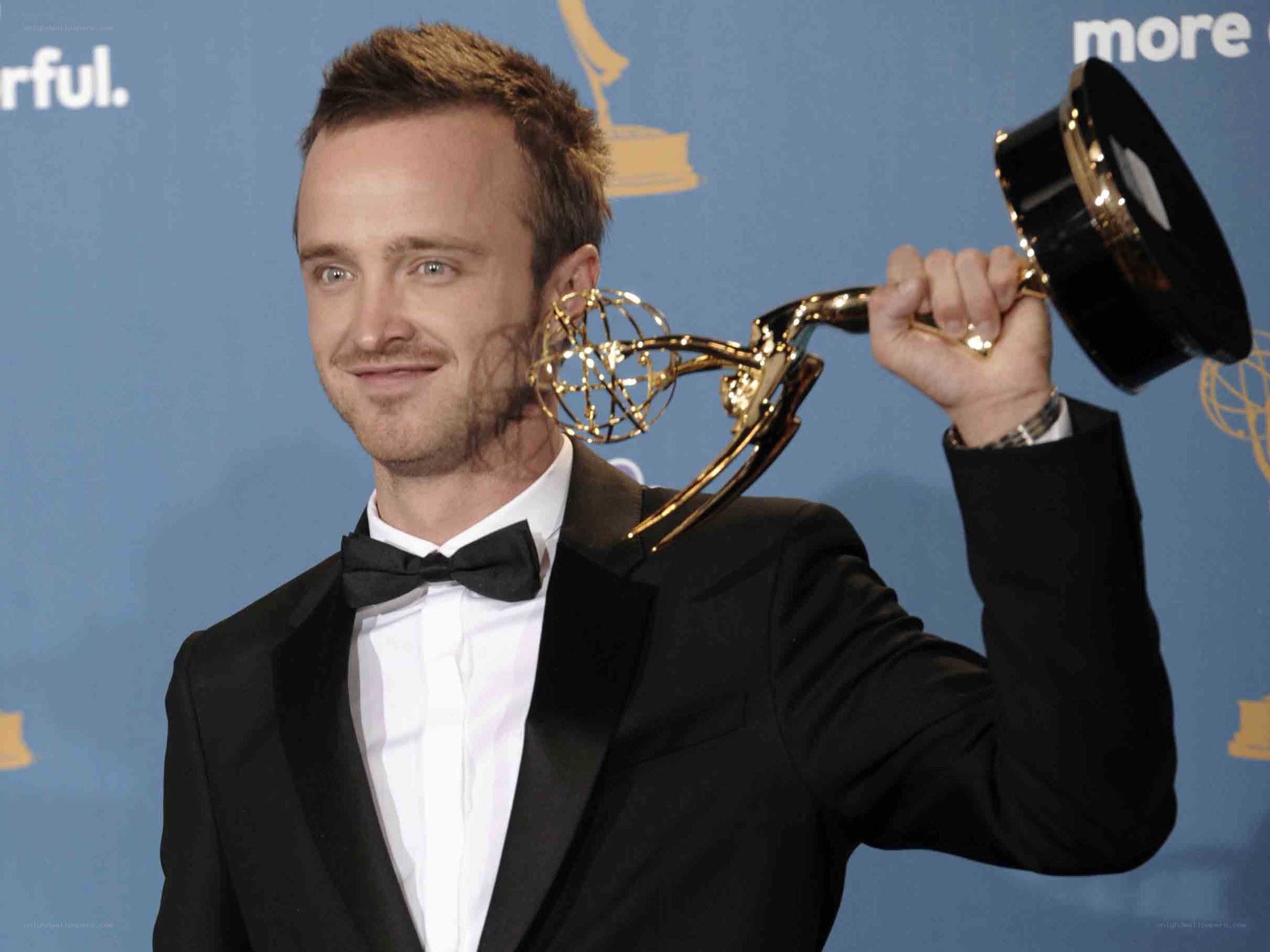 actor holding emmy award
