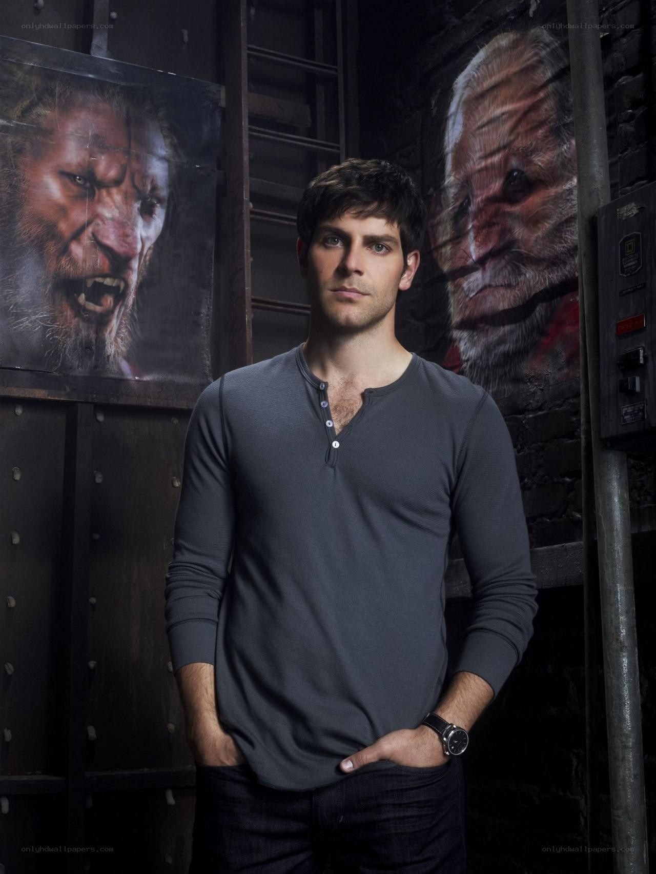 actor in dark room with monster posters