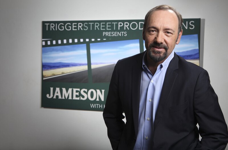 actor in front of promotional sign