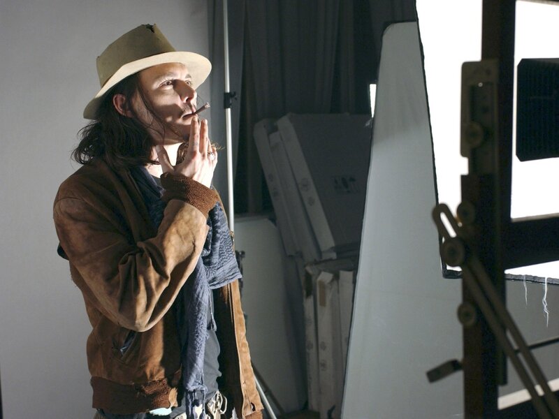actor in hat smoking cigarette