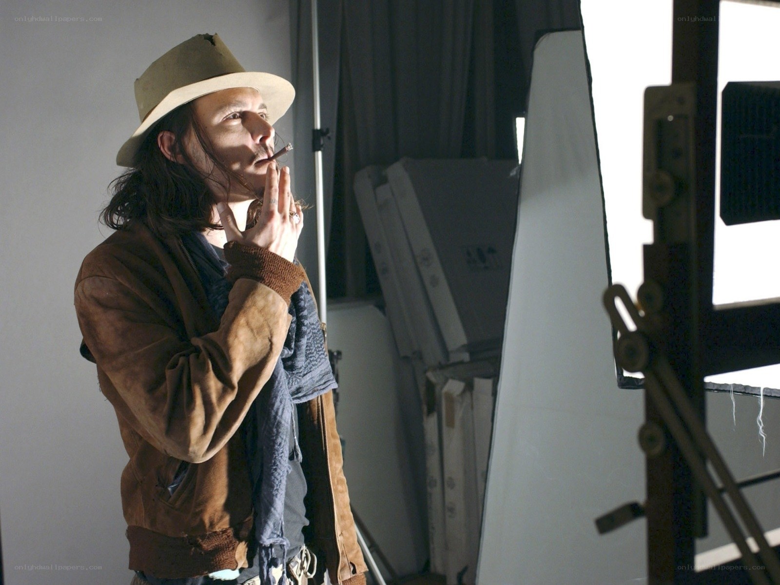 actor in hat smoking cigarette
