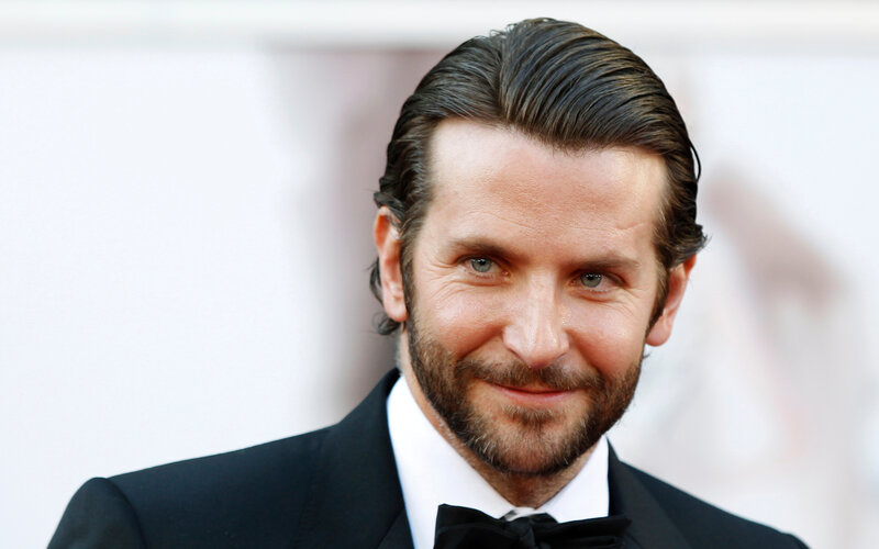 actor in tuxedo smiling