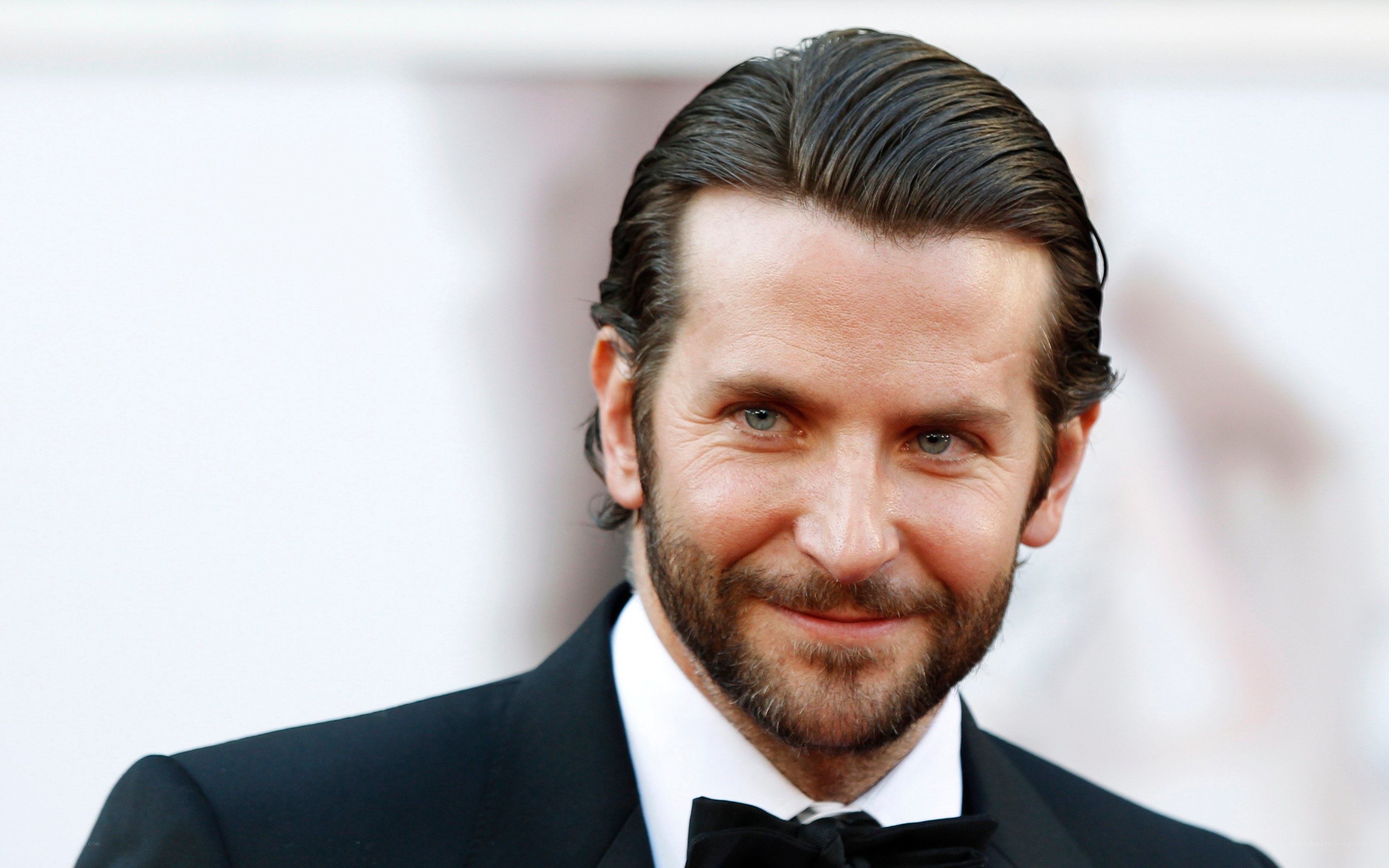 actor in tuxedo smiling