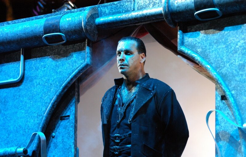 actor on stage in dark costume