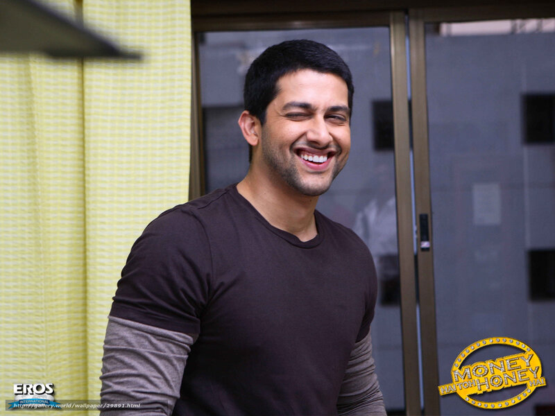 actor smiling in brown shirt