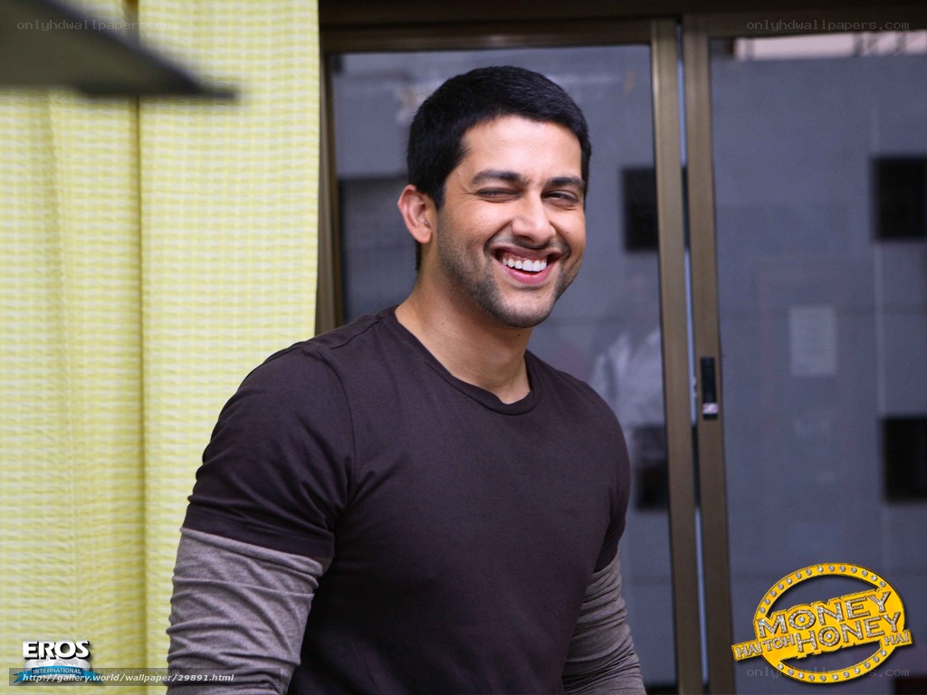 actor smiling in brown shirt