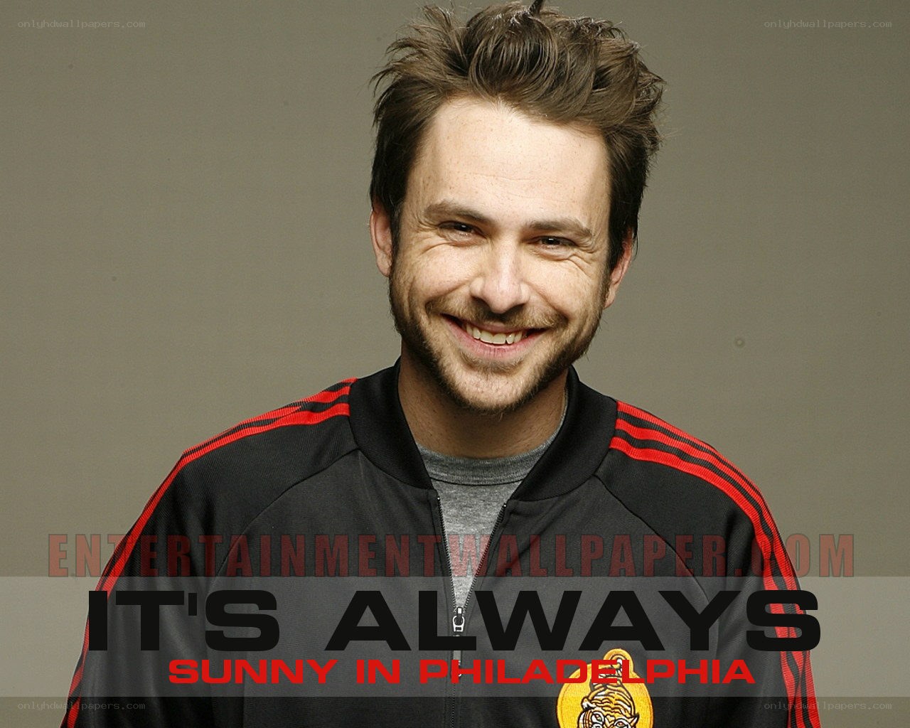 actor smiling in track jacket