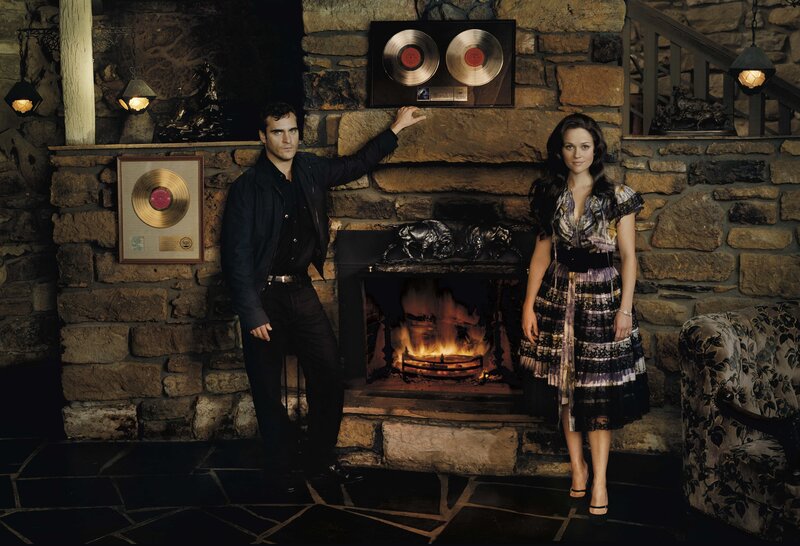 Actors by a fireplace