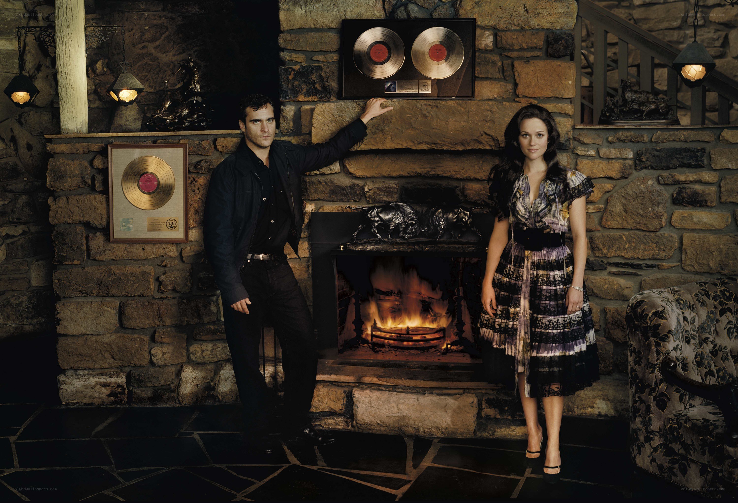 Actors by a fireplace