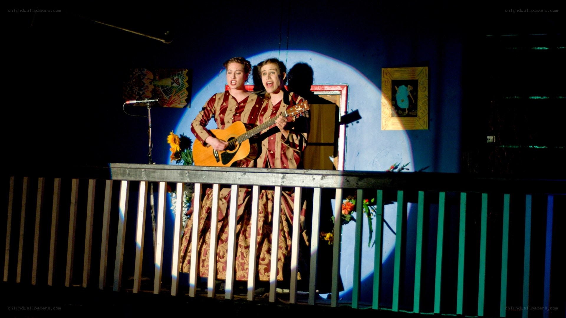 Actors on a stage balcony