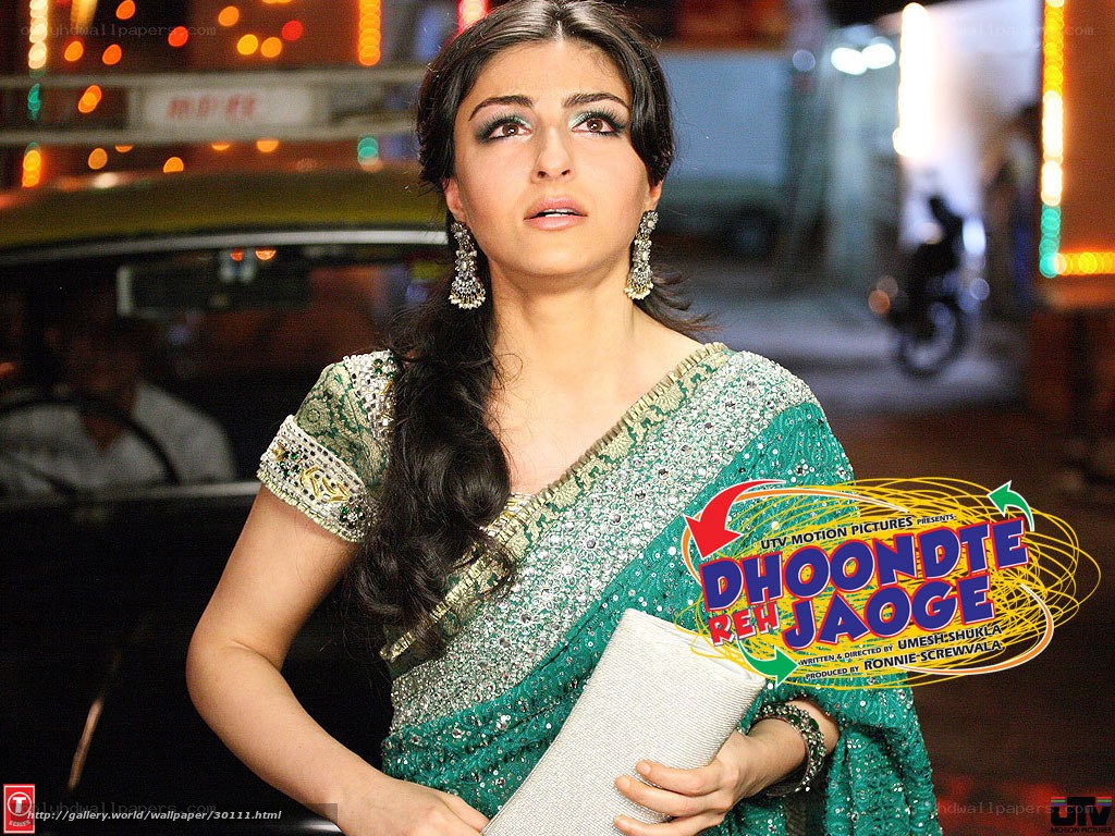 Actress in green sari at night