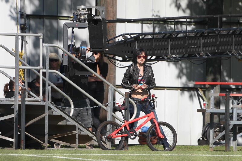 Actress on film set with bike
