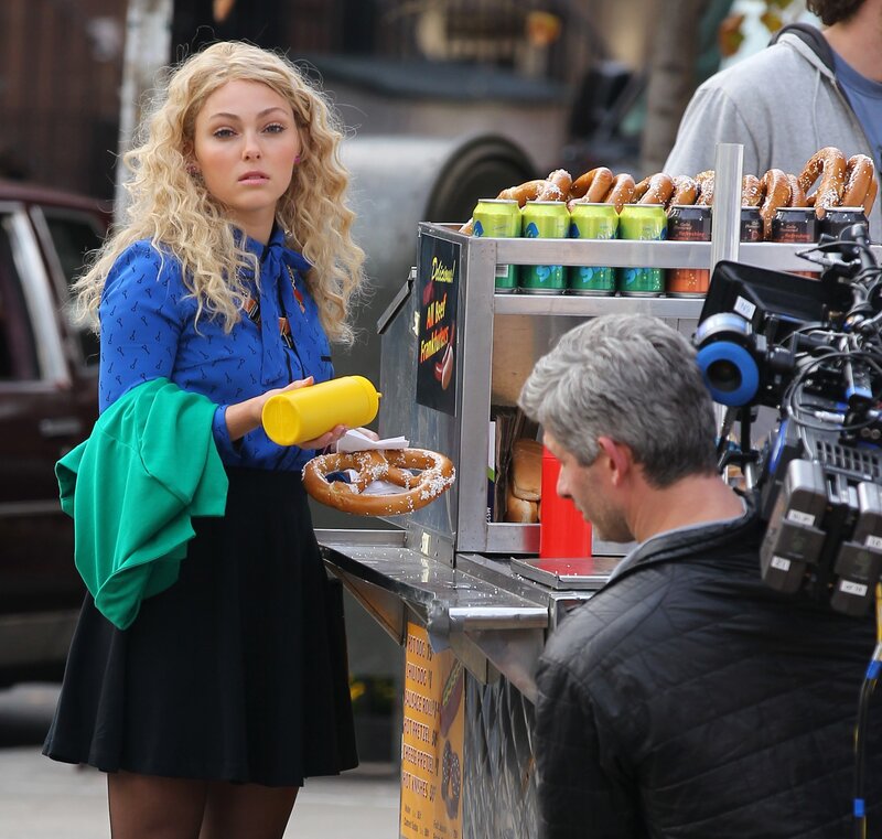 Actress on film set with pretzel