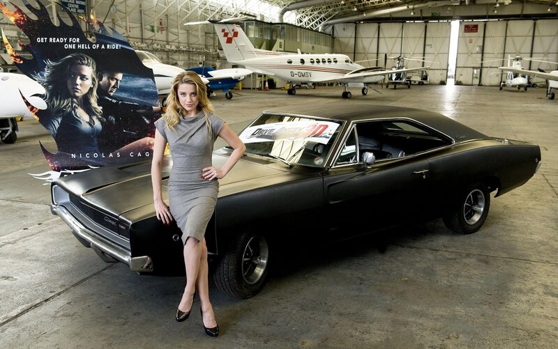 Actress with classic car in hangar