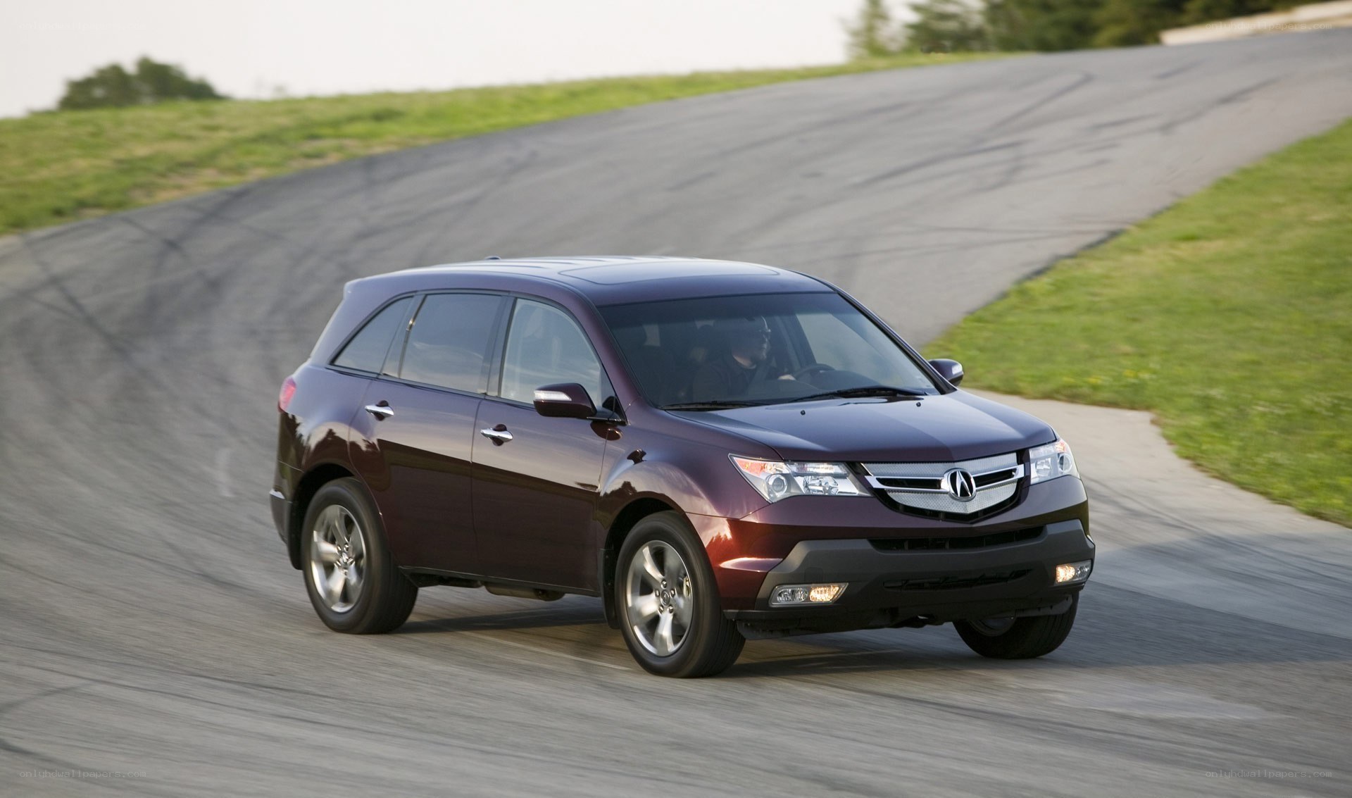 Acura MDX driving on a track