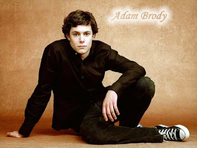 Adam Brody posing on floor
