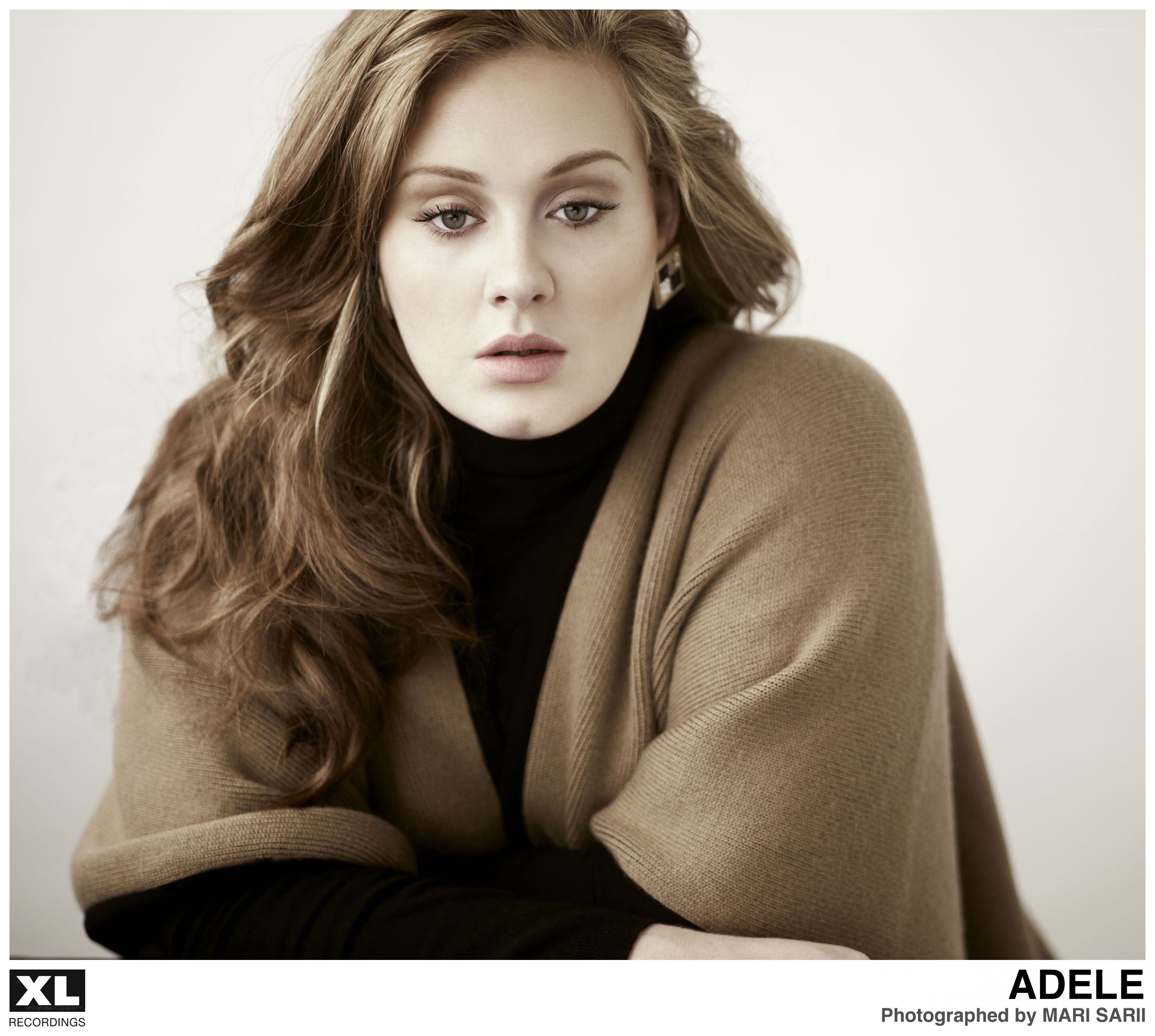 Adele in a brown cardigan