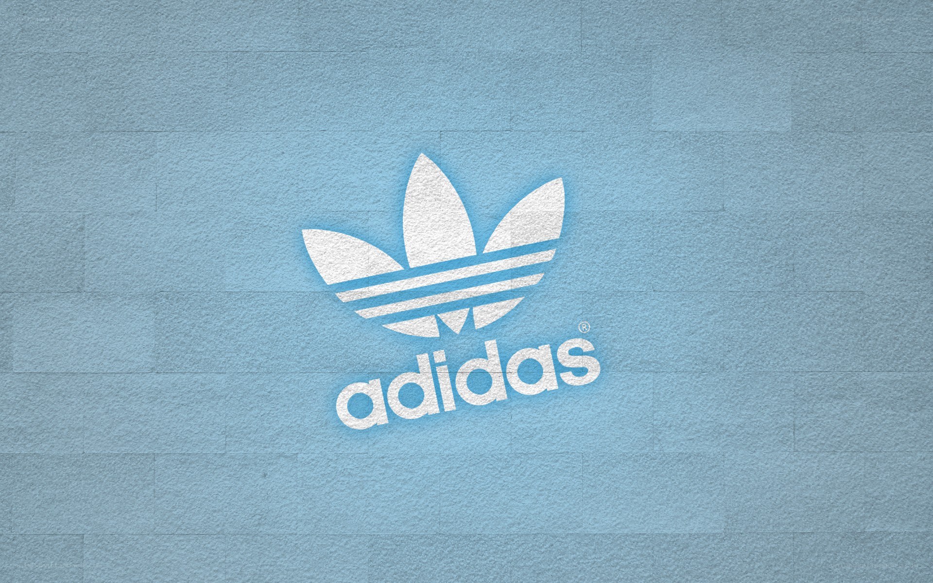 Adidas logo on blue wall