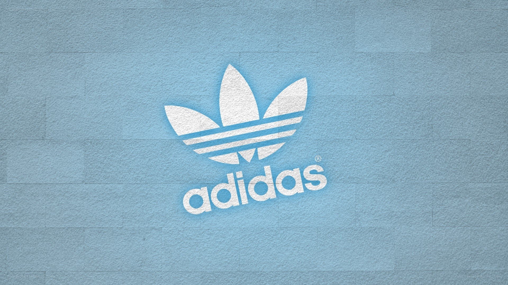 Adidas logo on blue wall