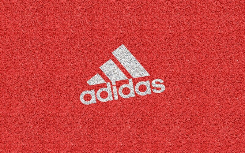 Adidas logo on red track