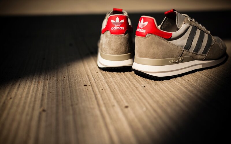 Adidas sneakers on wood floor